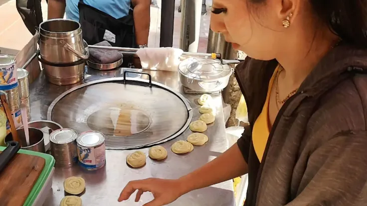 Once the stove is ready, the roti lady meticulously prepares her ingredients